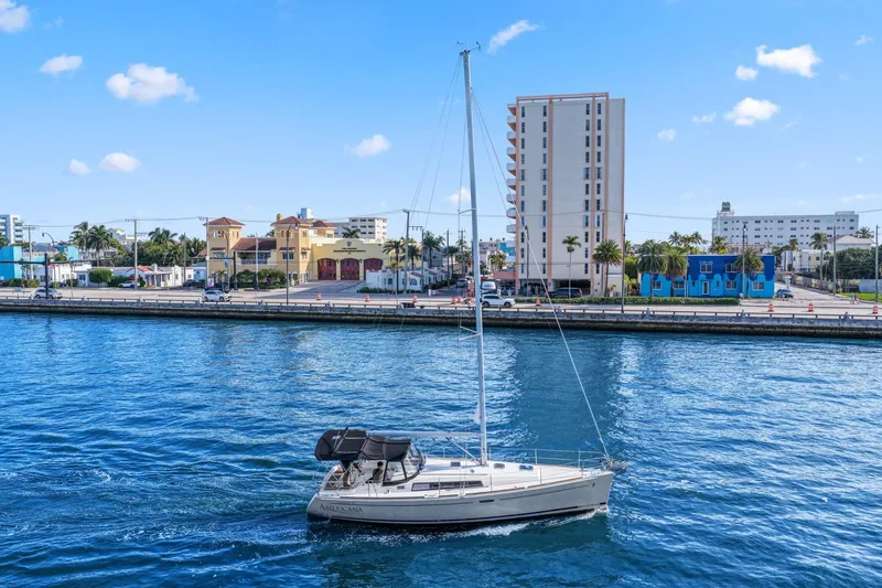 Slide: The Image of 2014 Beneteau Oceanis 37 sailboat cruising near urban waterfront buildings. - 7