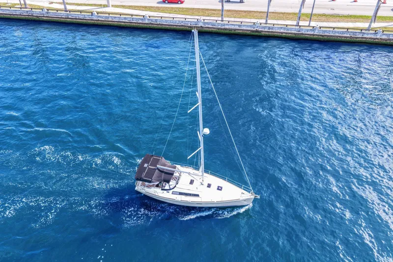 Slide: The Image of Aerial view of 2014 Beneteau Oceanis 37 sailboat cruising in blue waters near a shoreline. - 8