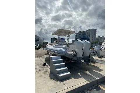 Slide: The Image of 2022 Zar Formenti 85 boat with twin engines, docked under cloudy skies. - 12