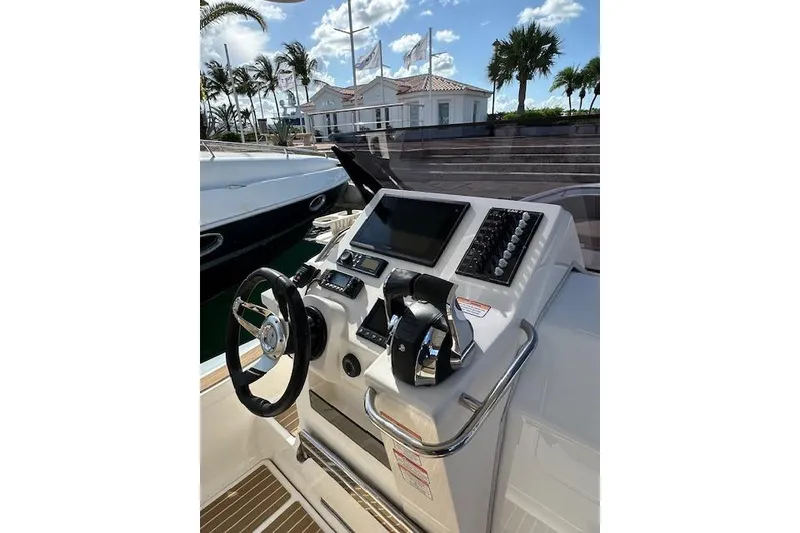 Slide: The Image of Control panel of 2022 Zar Formenti 85 boat with steering wheel and navigation display. - 4