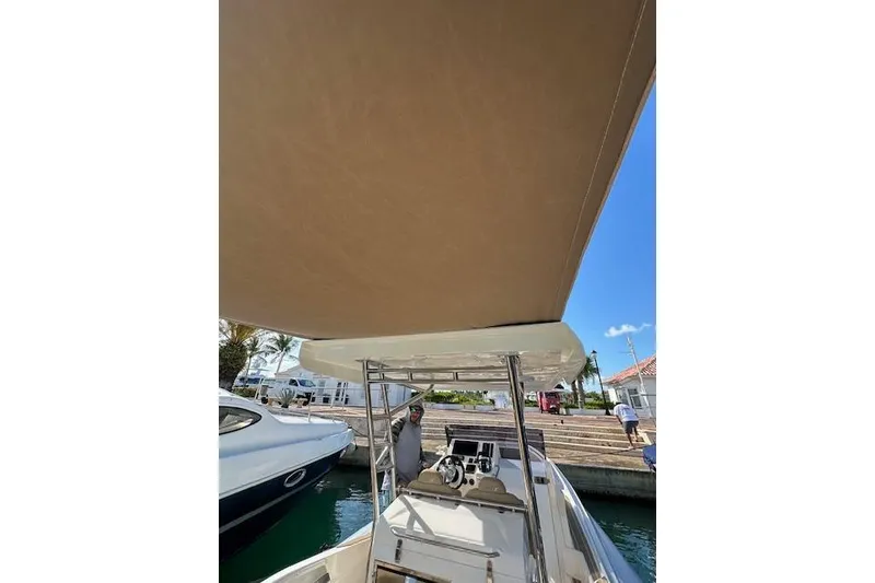 Slide: The Image of 2022 Zar Formenti 85 boat with canopy, docked at marina under clear blue sky. - 5