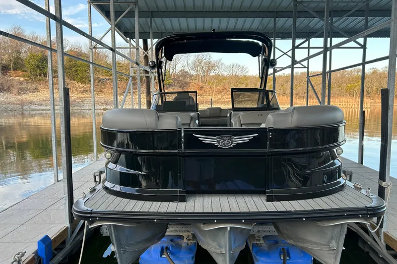 Slide: The Image of 2020 Avalon 2785 Excaliber pontoon boat docked under a covered structure. - 3