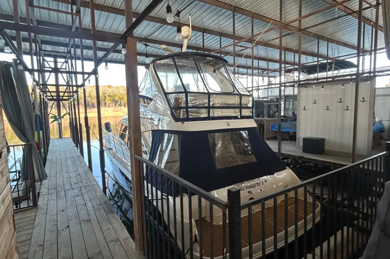 Slide: The Image of 2005 Sea Ray 44 Sedan Bridge yacht docked in covered marina. - 12