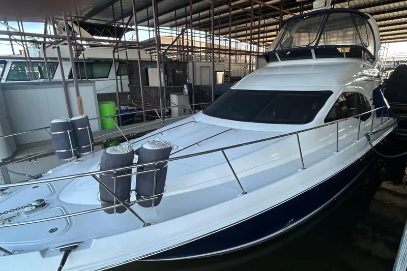 Slide: The Image of 2005 Sea Ray 44 Sedan Bridge yacht docked in a marina. - 13