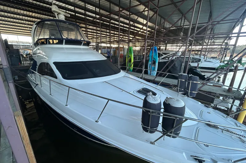 Slide: The Image of 2005 Sea Ray 44 Sedan Bridge yacht docked in a covered marina. - 16
