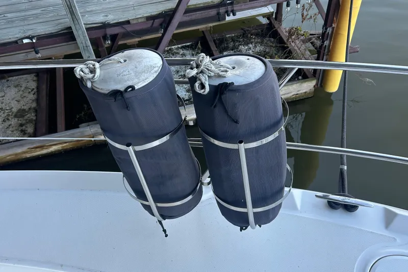 Slide: The Image of Boat fenders on a 2005 Sea Ray 44 Sedan Bridge, docked near wooden pier. - 20