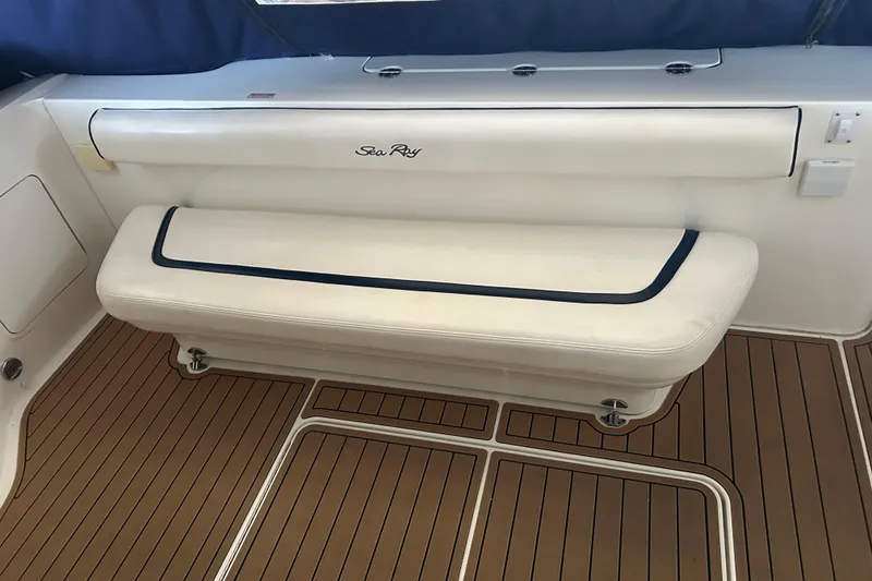 Slide: The Image of 2005 Sea Ray 44 Sedan Bridge interior with cushioned seating and teak flooring. - 25