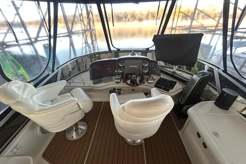 Slide: The Image of 2005 Sea Ray 44 Sedan Bridge helm with white seats and panoramic view. - 30