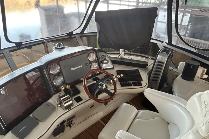 Slide: The Image of 2005 Sea Ray 44 Sedan Bridge helm with Raymarine electronics and leather seating. - 33