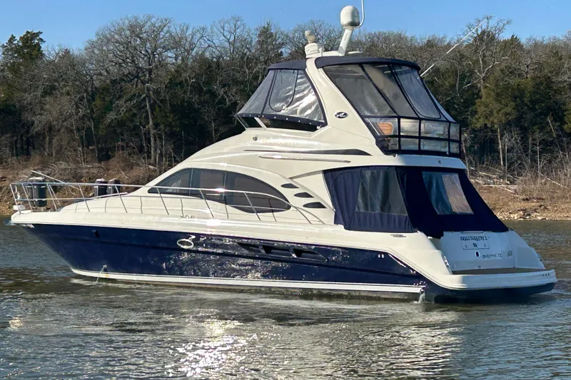 Slide: The Image of 2005 Sea Ray 44 Sedan Bridge yacht cruising on a calm lake. - 4