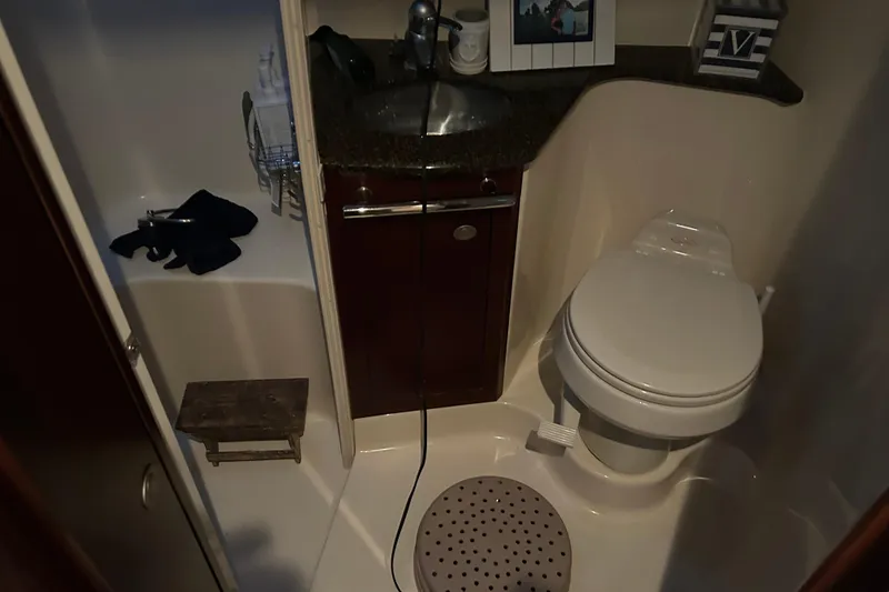Slide: The Image of 2005 Sea Ray 44 Sedan Bridge bathroom with sink, toilet, and shower area. - 41