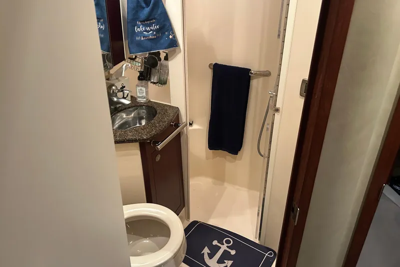 Slide: The Image of Bathroom interior of 2005 Sea Ray 44 Sedan Bridge yacht, featuring sink and shower. - 43