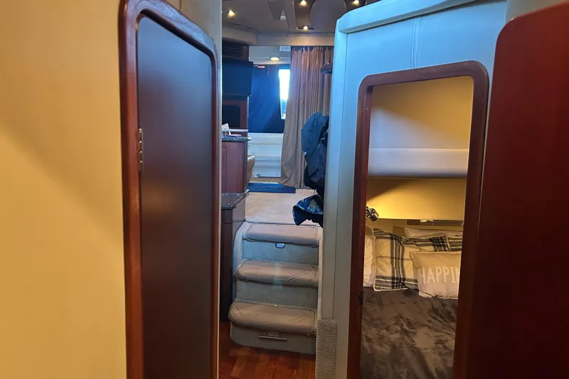 Slide: The Image of Interior view of 2005 Sea Ray 44 Sedan Bridge yacht, featuring cozy cabin and stairs. - 44