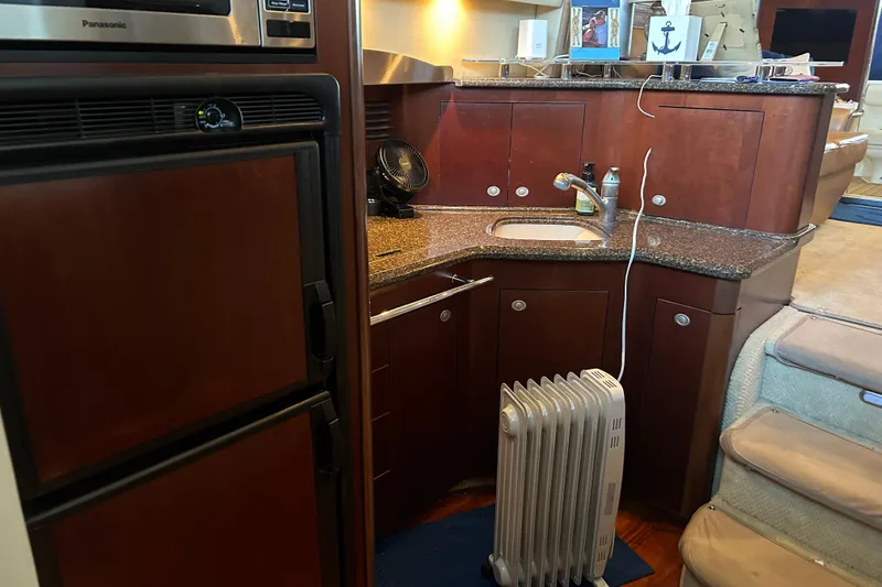 Slide: The Image of 2005 Sea Ray 44 Sedan Bridge yacht interior with kitchenette and appliances. - 46