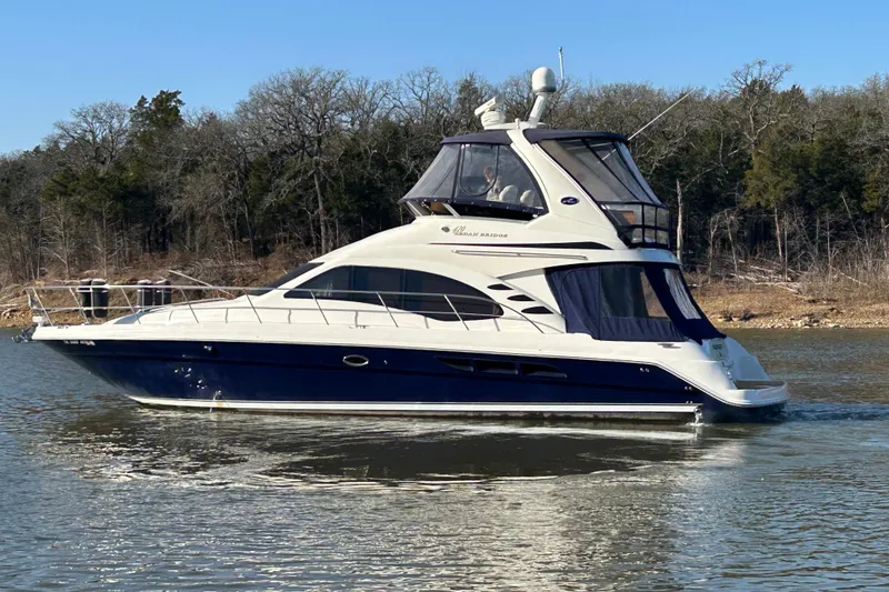 Slide: The Image of 2005 Sea Ray 44 Sedan Bridge yacht cruising on a calm lake. - 9