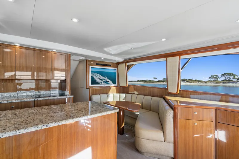 Slide: The Image of Luxurious interior of 2007 Viking 56 Convertible yacht with elegant wood finishes and scenic window views. - 13