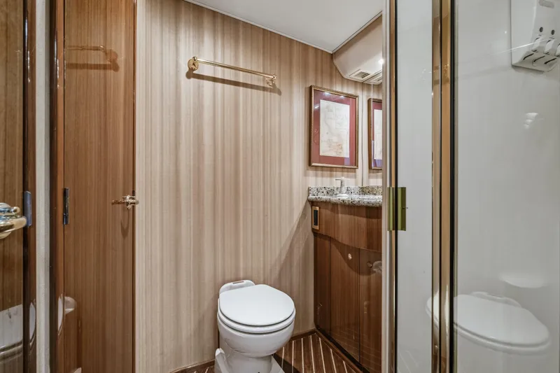 Slide: The Image of Luxurious bathroom in 2007 Viking 56 Convertible yacht with wood accents and granite countertop. - 21