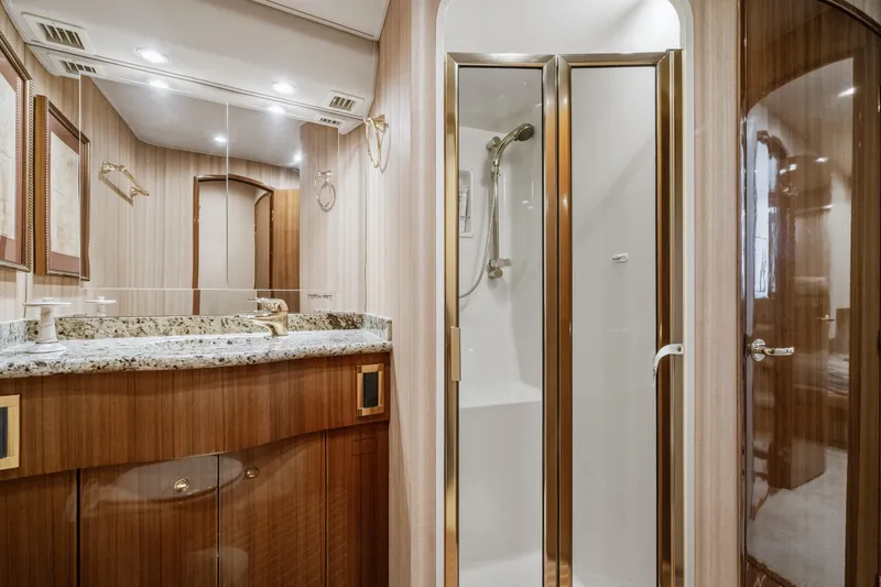 Slide: The Image of Luxurious bathroom in 2007 Viking 56 Convertible yacht with granite countertop and glass shower. - 23
