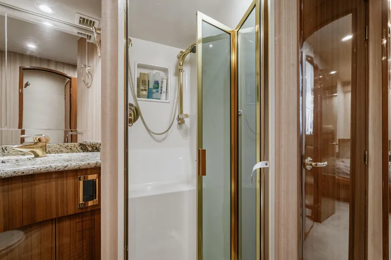 Slide: The Image of Luxurious bathroom in 2007 Viking 56 Convertible yacht with granite countertop and glass shower. - 24