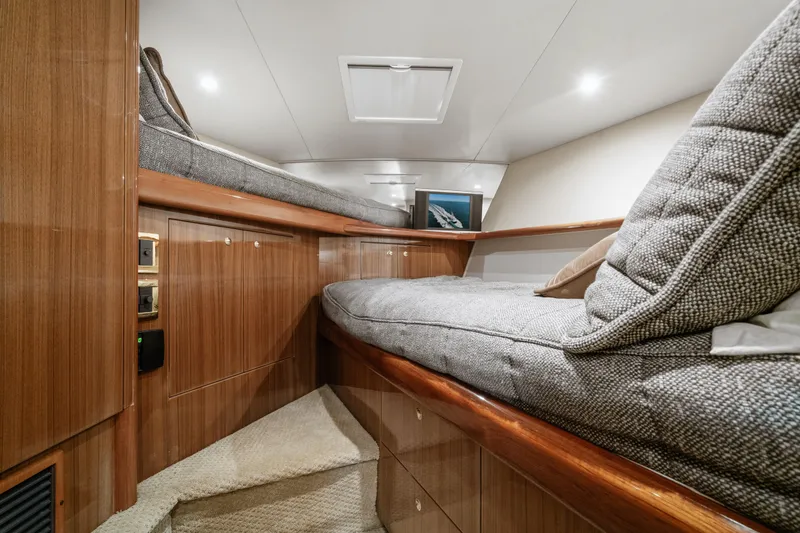 Slide: The Image of Interior cabin of 2007 Viking 56 Convertible yacht with wooden finish and cozy bedding. - 26