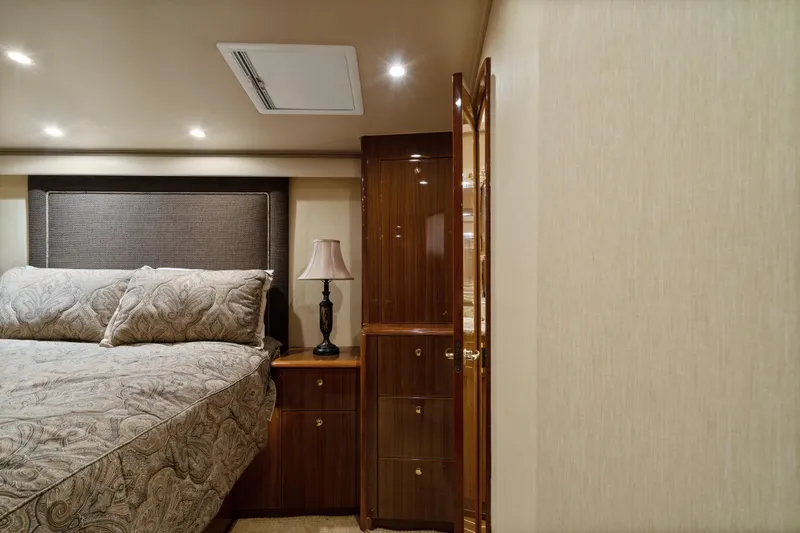 Slide: The Image of Luxurious bedroom interior of 2007 Viking 56 Convertible yacht with elegant bedding and wood cabinetry. - 29