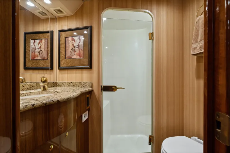 Slide: The Image of Luxurious bathroom in 2007 Viking 56 Convertible yacht with granite countertop and glass shower. - 32