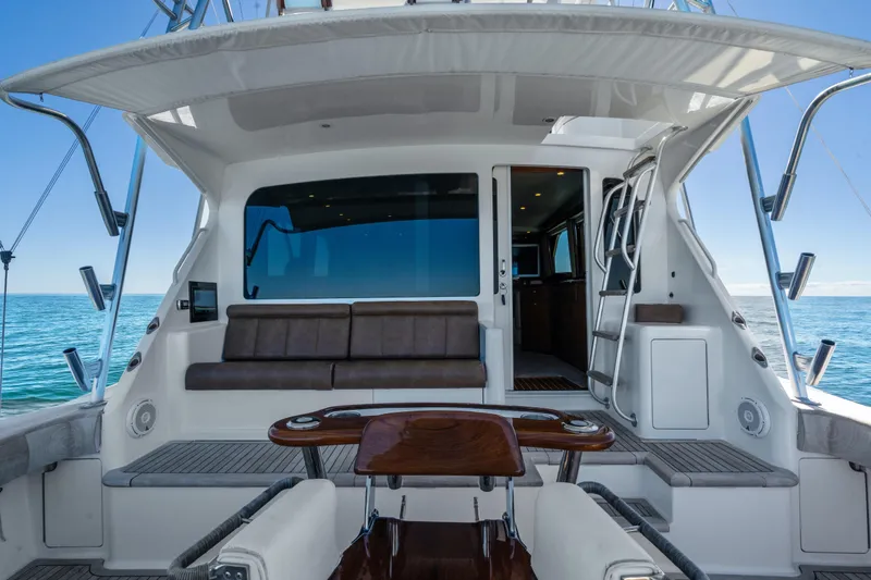 Slide: The Image of 2007 Viking 56 Convertible yacht interior with seating, ocean view, and ladder access. - 34