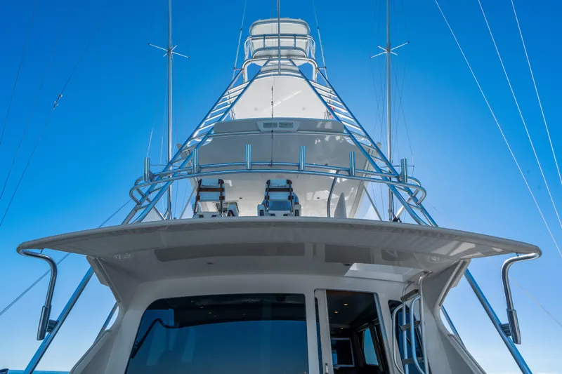 Slide: The Image of 2007 Viking 56 Convertible yacht, viewed from below against a clear blue sky. - 35