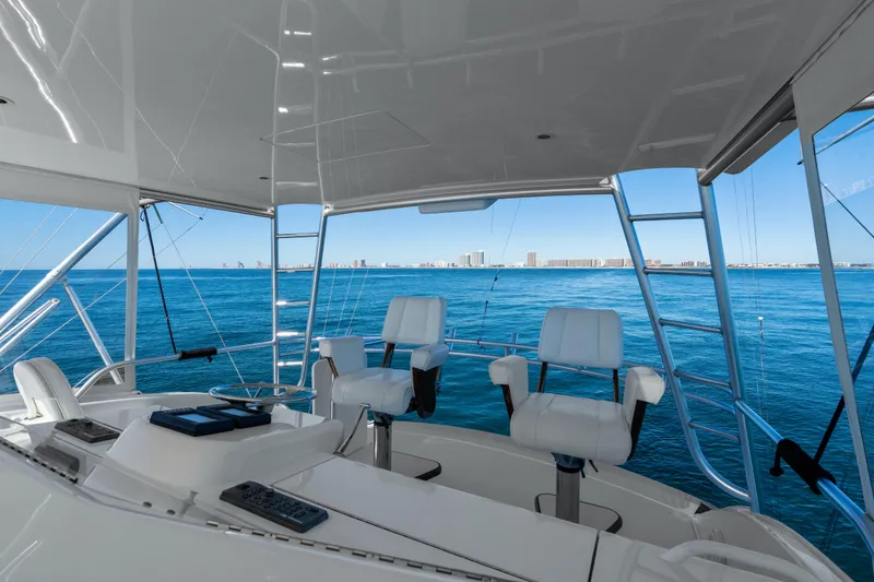 Slide: The Image of Helm of 2007 Viking 56 Convertible yacht with ocean view and city skyline. - 40