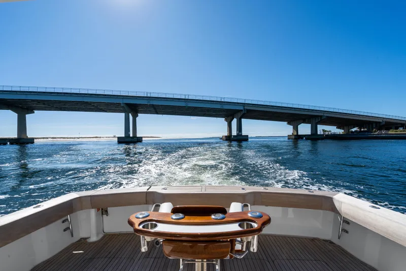 Slide: The Image of 2007 Viking 56 Convertible yacht cruising under a bridge on a sunny day. - 43