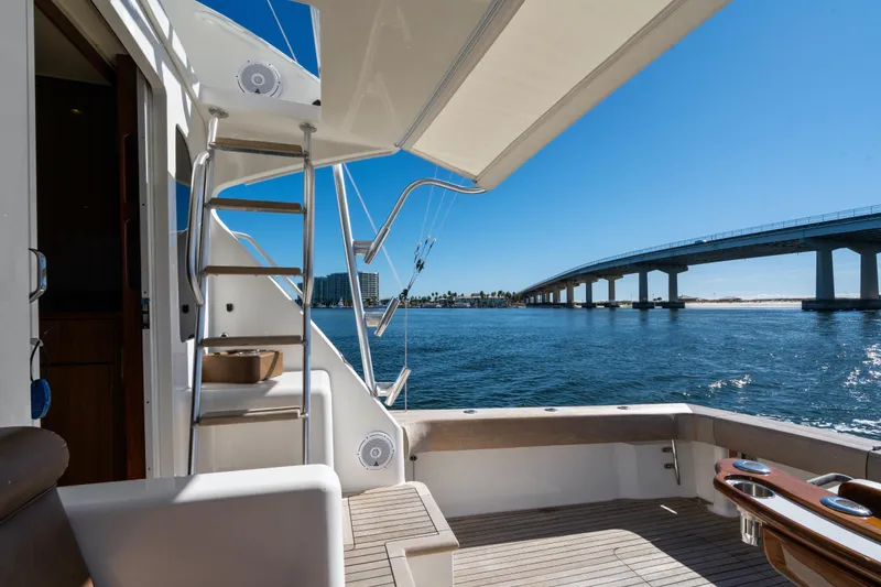Slide: The Image of 2007 Viking 56 Convertible yacht deck with ocean view and bridge in background. - 44