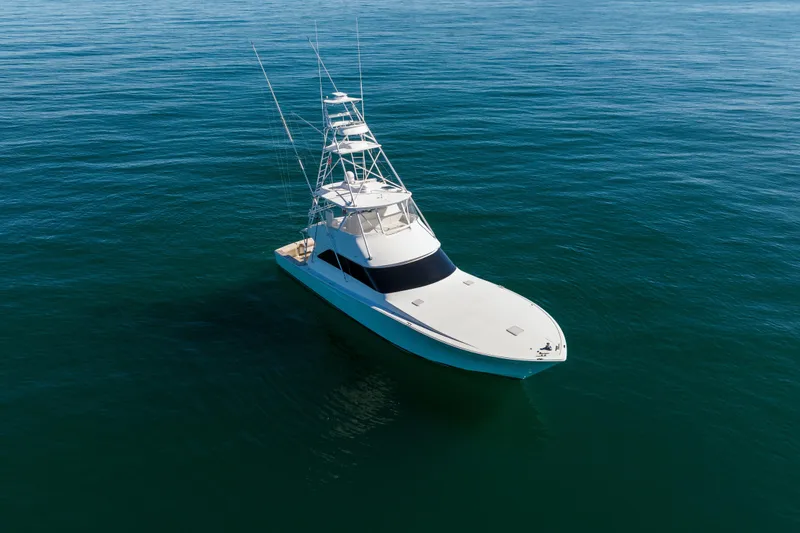 Slide: The Image of 2007 Viking 56 Convertible yacht on calm ocean waters. - 5