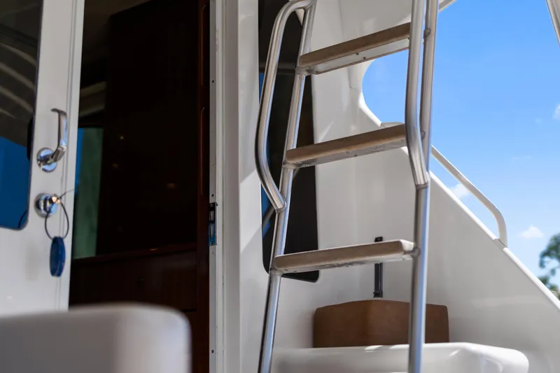 Slide: The Image of Stainless steel ladder on 2007 Viking 56 Convertible yacht, with open cabin door. - 54