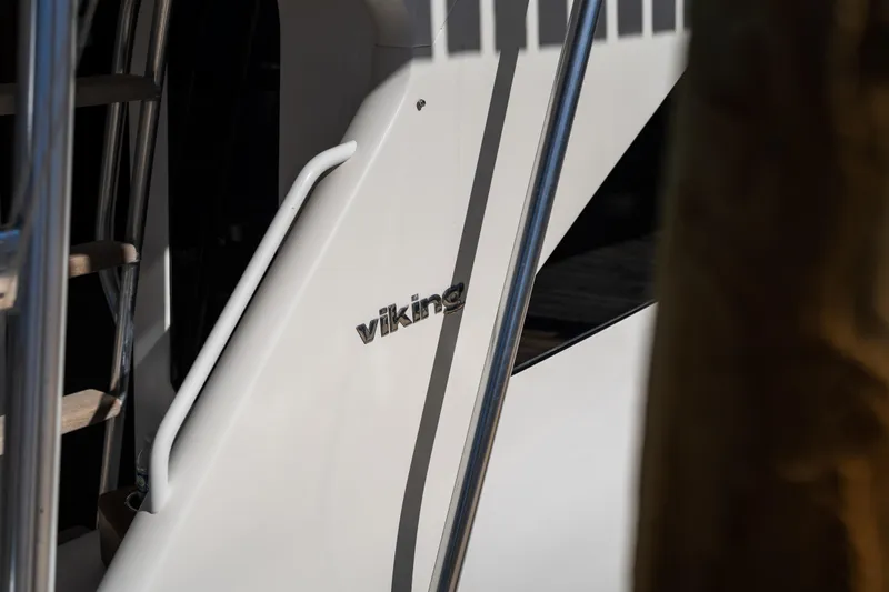 Slide: The Image of Close-up of 2007 Viking 56 Convertible yacht with logo and railing. - 57