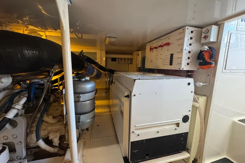 Slide: The Image of Engine room of a 2007 Viking 56 Convertible yacht, showcasing machinery and control panels. - 65
