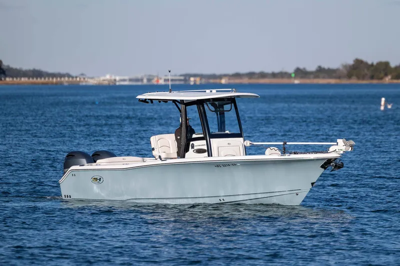 The Image of 2021 Sea Hunt Ultra 265 SE boat on calm blue water. - 0