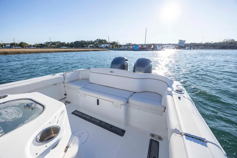 Slide: The Image of 2021 Sea Hunt Ultra 265 SE boat on water, featuring dual engines and spacious seating. - 18