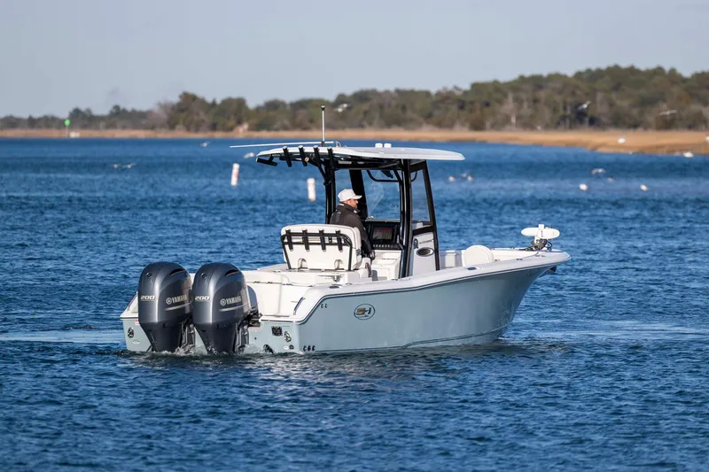 Slide: The Image of 2021 Sea Hunt Ultra 265 SE boat cruising on a calm blue lake. - 2
