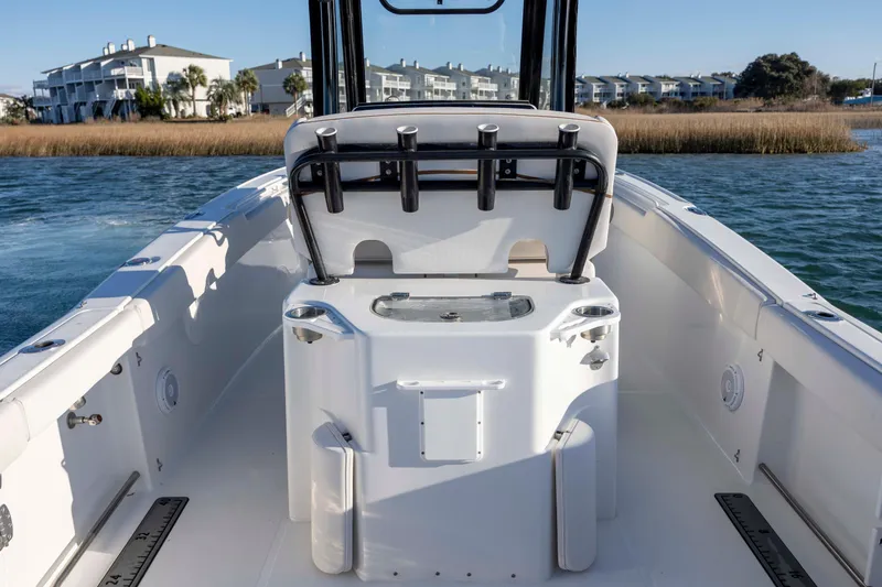 Slide: The Image of 2021 Sea Hunt Ultra 265 SE boat interior with fishing rod holders and seating. - 20