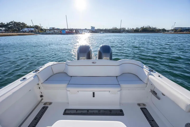 Slide: The Image of 2021 Sea Hunt Ultra 265 SE boat with dual engines on a sunny day. - 22