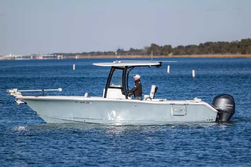 Slide: The Image of 2021 Sea Hunt Ultra 265 SE boat cruising on a calm blue lake. - 5