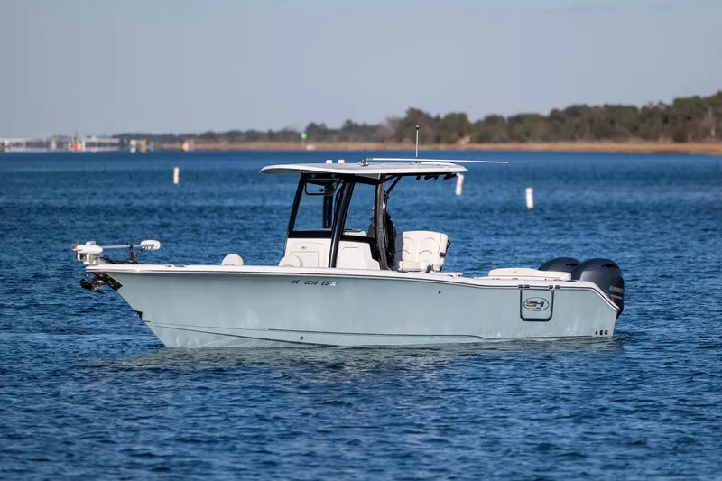 Slide: The Image of 2021 Sea Hunt Ultra 265 SE boat on calm water, side view. - 6