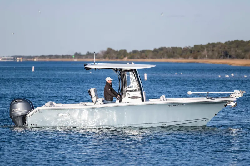 Slide: The Image of 2021 Sea Hunt Ultra 265 SE boat cruising on a calm blue lake. - 8