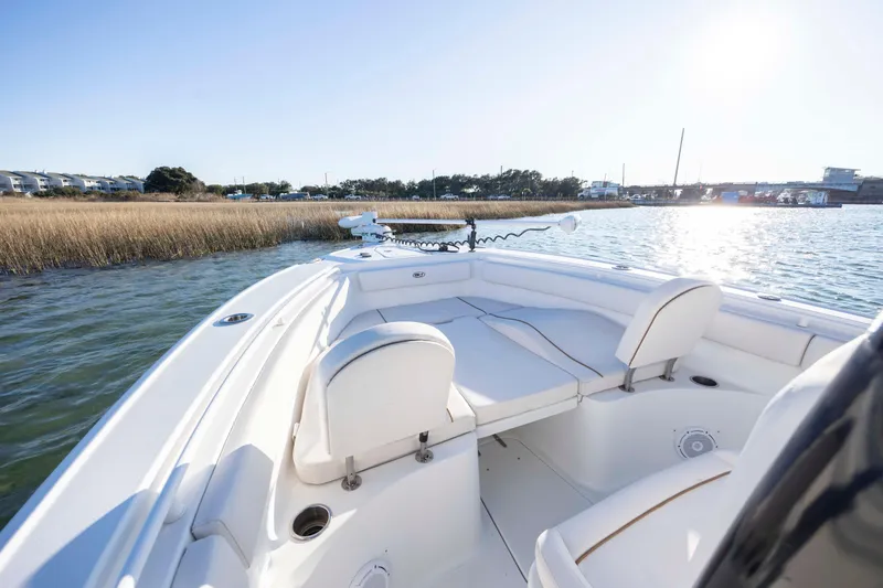 Slide: The Image of 2021 Sea Hunt Ultra 265 SE boat on calm water, sunny day, coastal view. - 9