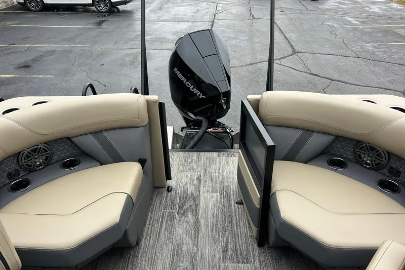 Slide: The Image of 2026 Viaggio Lago Z-Q boat interior with Mercury engine, featuring beige seating and cup holders. - 29