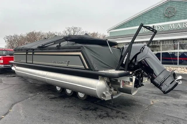 Slide: The Image of 2026 Viaggio Lago Z-Q pontoon boat with cover, parked outside a marina. - 32