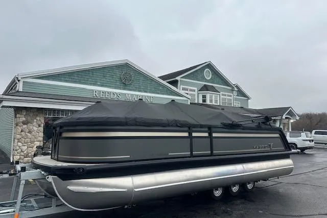 Slide: The Image of 2026 Viaggio Lago Z-Q pontoon boat covered, parked at Reeds Marine dealership. - 33