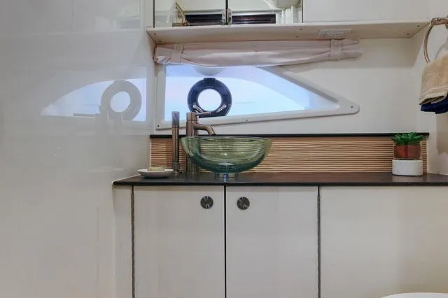 Slide: The Image of Engine compartment of 2022 Sea Ray Sundancer 320 Outboard, showcasing mechanical components and battery setup. - 12