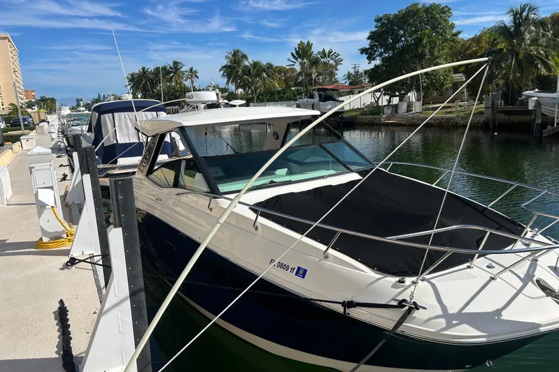 Slide: The Image of 2022 Sea Ray Sundancer 320 Outboard engine compartment with battery and wiring. - 15