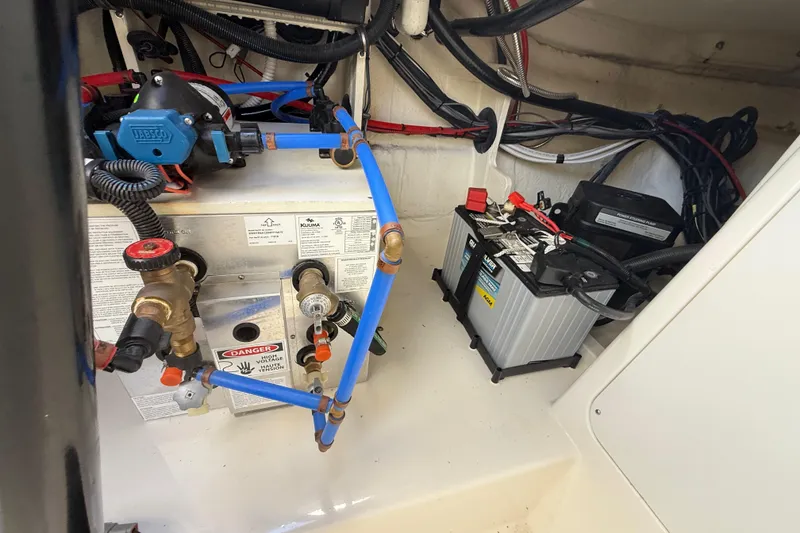 Slide: The Image of 2022 Sea Ray Sundancer 320 Outboard engine compartment with battery and wiring. - 18